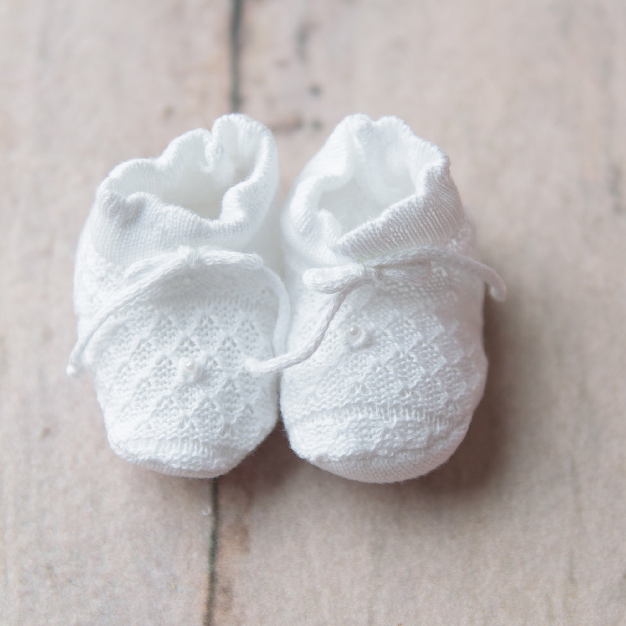 white knitted baby booties